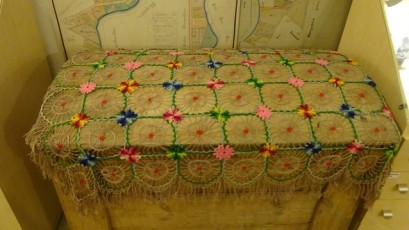 A decorative blanket on a chest in the regional museum